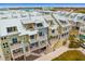 Aerial view of townhouses near the water with metal roofs and balconies at 19915 Gulf Blvd # 303, Indian Shores, FL 33785