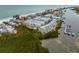 Aerial view of waterfront community, showcasing beach, homes, and boats at 19915 Gulf Blvd # 303, Indian Shores, FL 33785