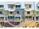 Close-up aerial view of multiple townhouses showcasing architectural details and balconies at 19915 Gulf Blvd # 303, Indian Shores, FL 33785