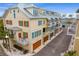 Aerial view of a row of townhouses with attached garages and metal roofs at 19915 Gulf Blvd # 303, Indian Shores, FL 33785