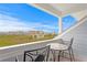 Private balcony with table and chairs, offering scenic ocean views at 19915 Gulf Blvd # 303, Indian Shores, FL 33785