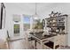 Bright dining room features a farmhouse table, chandelier, and built-in hutch at 19915 Gulf Blvd # 303, Indian Shores, FL 33785