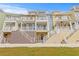 Three-story townhouses with multiple balconies and stairs at 19915 Gulf Blvd # 303, Indian Shores, FL 33785