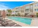 Inviting community pool area with lounge chairs and umbrellas at 19915 Gulf Blvd # 303, Indian Shores, FL 33785