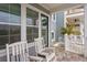 Front porch with white rocking chairs and wreath at 19915 Gulf Blvd # 303, Indian Shores, FL 33785