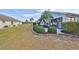 Backyard view showcasing a patio area and neatly trimmed shrubs at 243 Linger Ln, Sun City Center, FL 33573