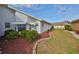 Landscaped backyard with red gravel and well-manicured lawn at 243 Linger Ln, Sun City Center, FL 33573