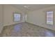 Bright bedroom featuring tile floors and two windows at 243 Linger Ln, Sun City Center, FL 33573