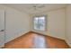 Simple bedroom with wood-look floors and window with blinds at 243 Linger Ln, Sun City Center, FL 33573