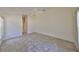 Spacious bedroom with tile floors and access to bathroom at 243 Linger Ln, Sun City Center, FL 33573