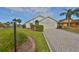 Single-story home with a paved driveway and landscaped front yard at 243 Linger Ln, Sun City Center, FL 33573