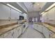 Bright kitchen with white cabinets and tile flooring at 243 Linger Ln, Sun City Center, FL 33573