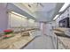 Galley kitchen with double sink and tile countertops at 243 Linger Ln, Sun City Center, FL 33573