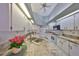 Spacious kitchen featuring white cabinets and tile countertops at 243 Linger Ln, Sun City Center, FL 33573