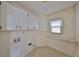 Laundry room with ample storage space and shelving at 243 Linger Ln, Sun City Center, FL 33573