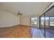 Living room with wood-look floors, large window, and sliding glass doors at 243 Linger Ln, Sun City Center, FL 33573