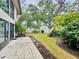 Spacious backyard with patio, grass, and various plants at 2750 E Bay Dr # 1E, Largo, FL 33771