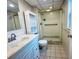 Bathroom with shower, toilet and white vanity at 2750 E Bay Dr # 1E, Largo, FL 33771