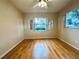 Well-lit bedroom featuring wood-look floors and multiple windows at 2750 E Bay Dr # 1E, Largo, FL 33771