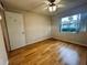 Spacious bedroom with wood-look floors and large window at 2750 E Bay Dr # 1E, Largo, FL 33771