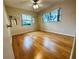 Large bedroom with wood-look floors and two windows at 2750 E Bay Dr # 1E, Largo, FL 33771