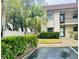 Condo building with lush green landscaping and parking at 2750 E Bay Dr # 1E, Largo, FL 33771