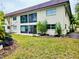 Back exterior view of a condo building with a grassy yard at 2750 E Bay Dr # 1E, Largo, FL 33771