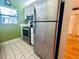 Stainless steel refrigerator in a galley-style kitchen at 2750 E Bay Dr # 1E, Largo, FL 33771