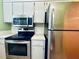 Kitchen with stainless steel appliances and microwave at 2750 E Bay Dr # 1E, Largo, FL 33771