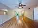 Spacious living room with light laminate wood flooring and ceiling fan at 2750 E Bay Dr # 1E, Largo, FL 33771