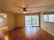 Living room with wood-look flooring, sliding doors, and ceiling fan at 2750 E Bay Dr # 1E, Largo, FL 33771