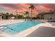 Community swimming pool with lounge chairs and palm trees at 2750 E Bay Dr # 1E, Largo, FL 33771