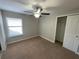 Bright bedroom with ceiling fan, window coverings, and large closet at 28489 Tranquil Lake Cir, Wesley Chapel, FL 33543