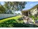 Spacious backyard with green grass, a large tree, and a white fence at 2930 49Th S Ter, St Petersburg, FL 33712