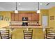 Bright kitchen with light wood cabinets and breakfast bar at 2930 49Th S Ter, St Petersburg, FL 33712