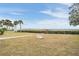 Spacious backyard with grassy lawn, two chairs, and waterfront views at 314 Shore E Dr, Oldsmar, FL 34677