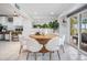 Bright dining area with round wooden table and white chairs, leading to a patio at 314 Shore E Dr, Oldsmar, FL 34677