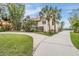 House exterior showcasing a landscaped yard, driveway, and architectural details at 314 Shore E Dr, Oldsmar, FL 34677