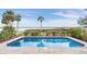 Enjoy this refreshing pool with water views and a spacious patio at 314 Shore E Dr, Oldsmar, FL 34677