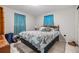 Cozy bedroom with a queen-size bed and teal bedding at 3303 Bainbridge Dr, Holiday, FL 34691