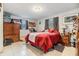 Bright bedroom featuring a queen bed and red bedding at 3303 Bainbridge Dr, Holiday, FL 34691