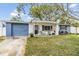 Adorable one-story home with newly painted exterior and inviting front porch at 3303 Bainbridge Dr, Holiday, FL 34691