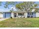 Adorable one-story home with newly painted exterior and inviting front porch at 3303 Bainbridge Dr, Holiday, FL 34691