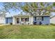 Adorable one-story home with newly painted exterior and inviting front porch at 3303 Bainbridge Dr, Holiday, FL 34691