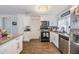 Modern kitchen with white cabinets and stainless steel appliances at 3303 Bainbridge Dr, Holiday, FL 34691