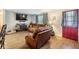 Cozy living room featuring leather furniture and wood-look tile floors at 3303 Bainbridge Dr, Holiday, FL 34691