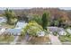 Aerial view of a home with a lake and lush trees in the background at 3510 Dellefield St, New Port Richey, FL 34655