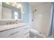 Updated bathroom with white tile shower and vanity at 3510 Dellefield St, New Port Richey, FL 34655