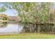 Peaceful canal view with lush greenery and wooden fence at 3510 Dellefield St, New Port Richey, FL 34655