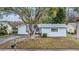 Light blue house exterior with a driveway and landscaping at 3510 Dellefield St, New Port Richey, FL 34655